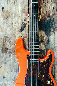 木本底的橙色电贝斯吉他音乐家爵士岩石细绳歌曲钢弦吉他手娱乐字符串乐器图片