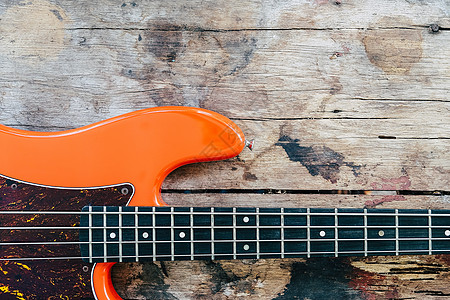 木本底的橙色电贝斯吉他歌曲橙子乐器木头爵士乐岩石音乐会棕色旋律音乐家图片
