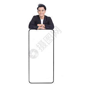 商务人士站在大智能手机后面 白屏幕的空白白屏幕背后图片