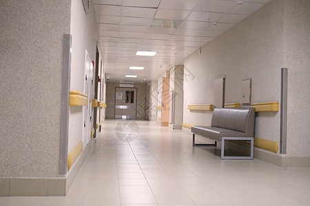 医院建筑一座大楼的空空长灰色走廊 没有人背景
