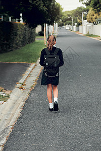 教育是我们为改善未来而走的一条路 年轻女学生步行上学的后视镜头图片