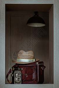两部镜头摄影摄像头前的帽子在Vintage棕色皮袋上旅游技术行李木头艺术滴漏收藏品材料乡愁配饰图片