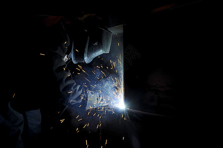 一个工人电焊机在一个半自动工厂里做钢铁蓝色工业火焰运动工作金属宇宙焊接星星生产图片
