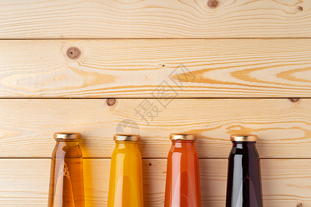 木制背景平地上的果汁瓶工作室水果盗版液体木头玻璃食物饮料饮食橙子图片