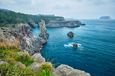 悬崖石头南韩济州岛爬坡海洋悬崖游客旅行旅游石头鹅卵石火山岩石背景