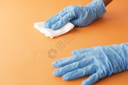 贴上人手用布料打扫桌解决方案橙子服务衣服卫生乳胶疾病消毒治疗背景图片