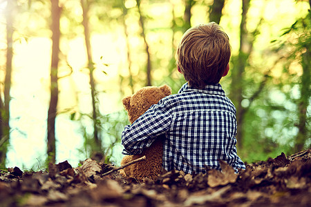 Teddy总是在我身边 被一个小男孩和他的泰迪熊坐在森林里图片