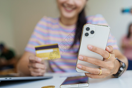在线购物和互联网支付 美丽的亚洲女性肖像正在使用信用卡和手机在线购物或在数字世界中办事幸福电脑摄影女士商业金融信用网上购物享受银图片