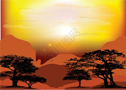 沙漠中的日出 显示太阳的浅红颜色和岩石 以及阳光的深红色图片