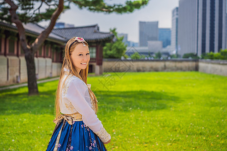 在景福宫穿着韩服的年轻白人女游客 前往韩国的概念 韩国民族服装 游客娱乐试穿韩国民族服饰裙子传统历史建筑学寺庙旅行城市女士街道衣图片