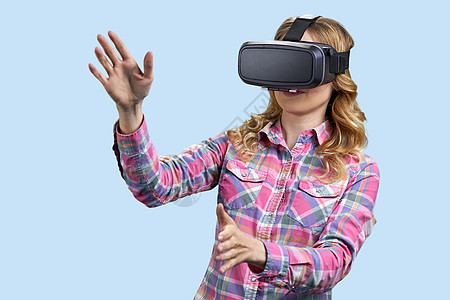兴奋的年轻女性在彩色背景上使用虚拟现实眼镜图片