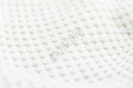 柔软和白色的暖湿编织衣服纹理毛衣手工织物服装壁橱折叠时装针织羊毛图片