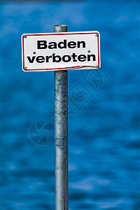 带有红色边框的德国标志— 禁止游泳 — 在水体前图片