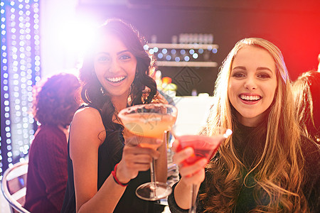 庆祝时间到了 两个年轻女子在派对上喝鸡尾酒的肖像图片