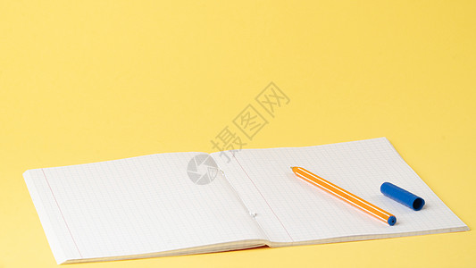 黄色背景 文字空间 学习的笔记本和笔放在桌上图片