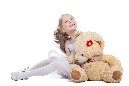 美丽的小女孩抱抱大泰迪熊图片