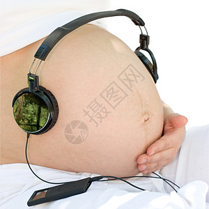 听音乐音乐播放器耳机白色刺激女性父母帽子怀孕孩子腹部图片