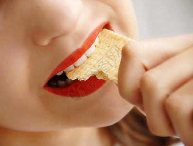女孩吃饼干压力微笑皮肤嘴唇牙齿早餐营养手指青少年淡黄色图片
