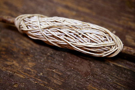旧木头上的旧线串圆形码头领带棕色力量细绳缠绕卷轴纤维绳索图片