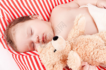 睡着的可爱小宝宝 在红色和白条纹枕头上生活女儿家庭新生女孩眼睛男生毯子童年压痛生活方式高清图片素材
