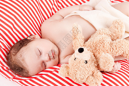 睡着的可爱小宝宝 在红色和白条纹枕头上说谎婴儿毯子男生新生时间皮肤女孩童年孩子舒服的高清图片素材
