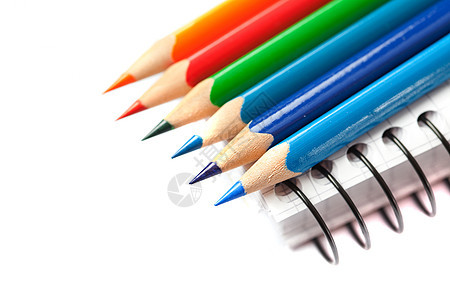 彩色铅笔和白纸上分离的笔记本彩虹宏观木头工具爱好工作办公室金属蓝色写作图片