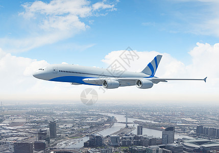 飞越城市上空的白色客机旅游景观全景航程生活旅行地平线蓝色风景摩天大楼图片