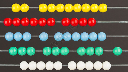 灰色背景的算盘特写白色绿色教育木头总和红色办公用品黑色工具数字图片