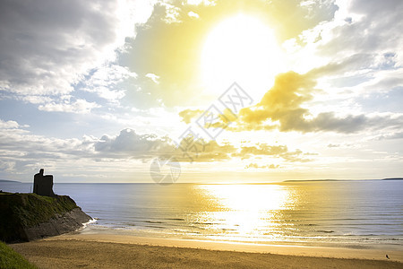 贝利比乌尼翁海滩和城堡上的黄太阳图片