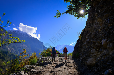 在阳光明媚的白天 两个人在山上旅行图片