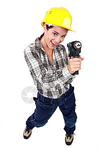 有电钻的女人建设者女士蛀虫女性乐器衬衫锤子力量工人头盔图片