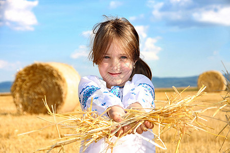 在收割田带草篮的农村小女孩粮食植物太阳干草食物女孩季节收成乐趣稻草图片