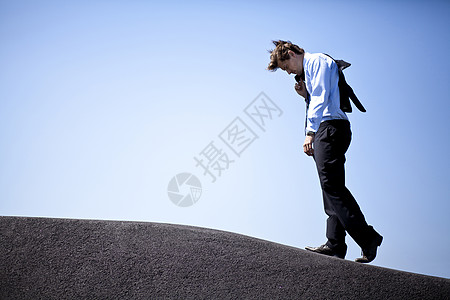 商务人士攀登山丘图片