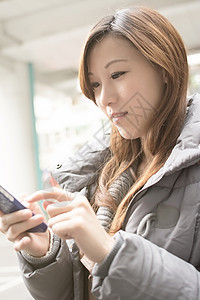 使用手机的亚洲年轻妇女魅力电话技术女士女性互联网电子邮件网络短信图片