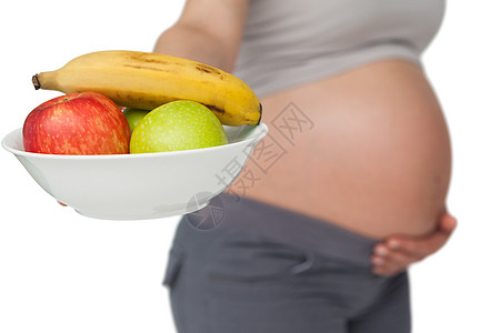 孕妇用照相机看水果碗的怀孕健康健康饮食女士母亲准妈妈红色水果腹部绿色图片
