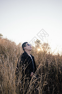 青壮男子在草地上与日出插图男人天空地平线调子风景监督狂喜森林日落图片