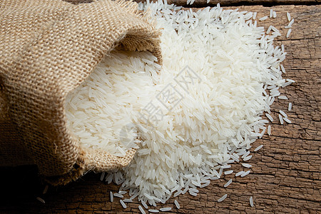 大米在布罗普麻袋米粒素食白米解雇帆布水稻种子木头图片