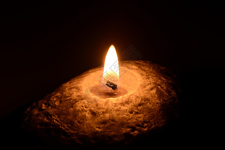 燃烧的蜡烛在黑背景上烧蜡烛冥想火焰烧伤宗教宏观黄色橙子白色假期温泉背景