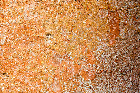 含橙色油漆和洗白液残余物的混凝土表面美白粉饰建造石墙风化水泥橙子石灰水石灰石膏图片
