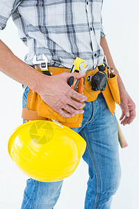腰和硬帽带工具带的技术员图片