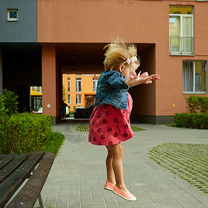 快乐的小女孩 金金发小金女孩跳活动金发女郎童年花园乐趣蓝色婴儿微笑公园运动图片