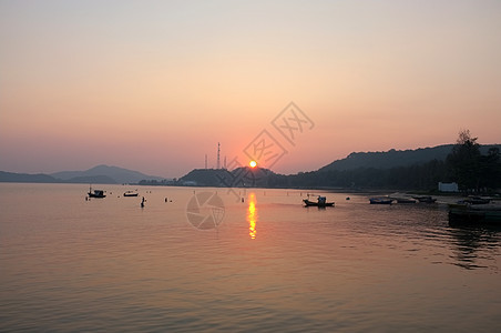 日落后海滩码头的海和山橙子海岸旅行岛屿支撑反射环境地平线日落场景图片