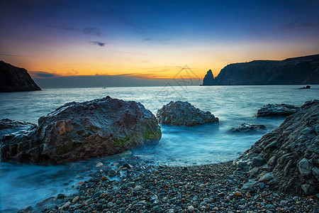 海滩日落戏剧性晴天假期海岸线海岸天空反射海洋蓝色紫色图片