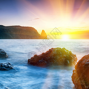 海滩日落墙纸晴天太阳天空天气海岸反射石头紫色季节图片