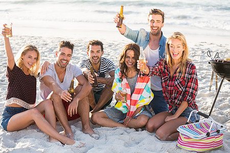 朋友在沙滩喝啤酒假期食物男人女性微笑感情快乐啤酒波浪海滩背景图片