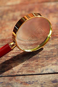 木头放大镜镜片阴影玻璃搜索工具调查商业背景图片