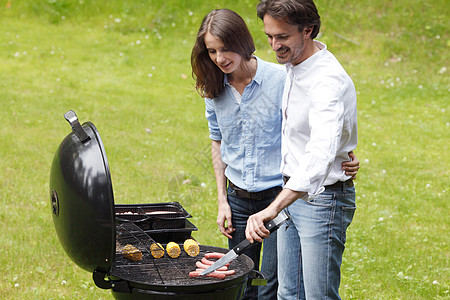 鸭架做烤烤肉的情侣烹饪花园闲暇炙烤草地野餐女士食物午餐男人香肠背景