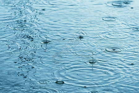 超慢运动中的雨滴水坑上的雨滴背景