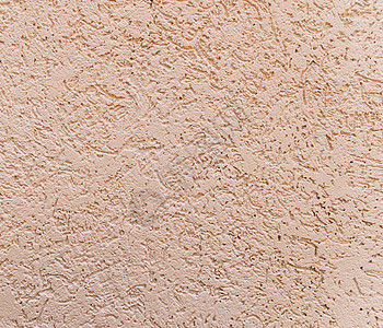 粉红色墙壁上装饰面石膏的背景水泥建筑风化阴影宽慰棕色工匠涂层材料建筑学图片