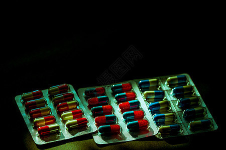 五颜六色的抗生素胶囊丸装在深色背景的泡罩包装中 带有复制空间 感染性疾病的药物 抗生素用药合理搭配 耐药性和医疗保健概念治愈伤口图片
